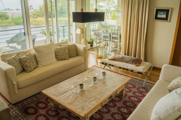 The interior of a modern apartment decorated comfortably with huge windows